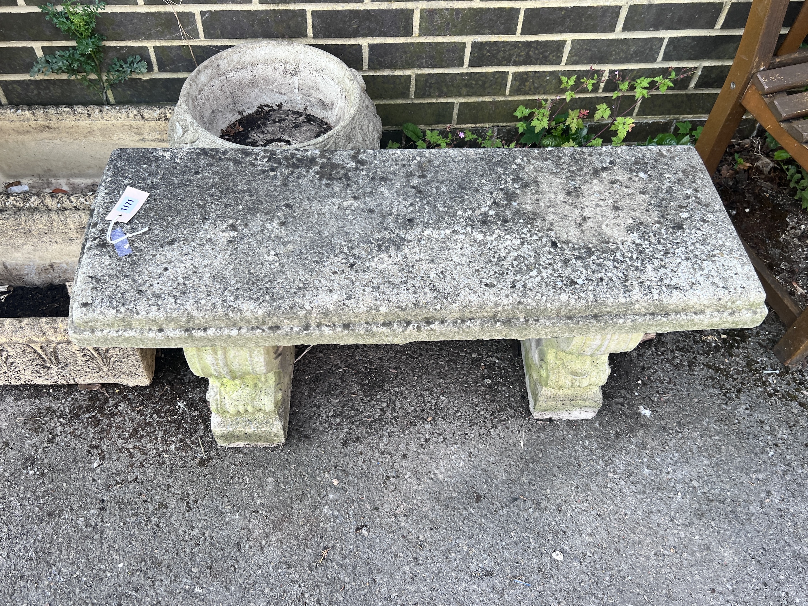 A reconstituted stone garden bench seat, length 98cm, depth 36cm, height 44cm